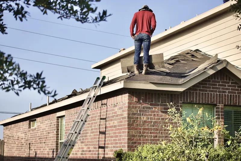 Professional roofer working on a residential roof in Coy Junction